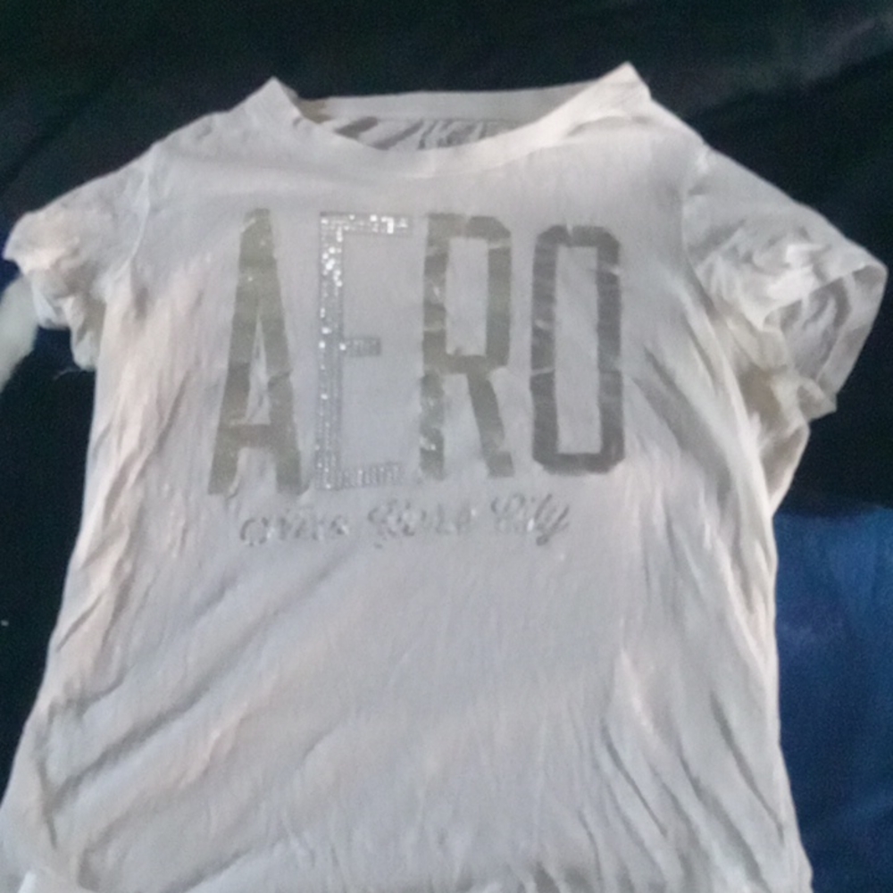 White Aero tee w/ pleated white skirt. Athletic outfit.